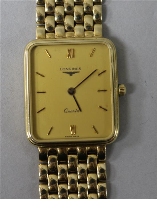 A gentlemans 9ct gold Longines Quartz wrist watch, on a 9ct Longines bracelet, with boxes.